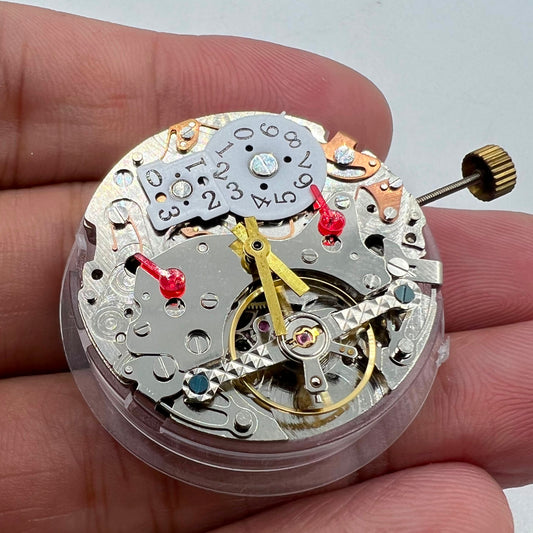 Close-up of Automatic Multifunctional Mechanical Watch with Date at 12 and Bare Wheel at 6
