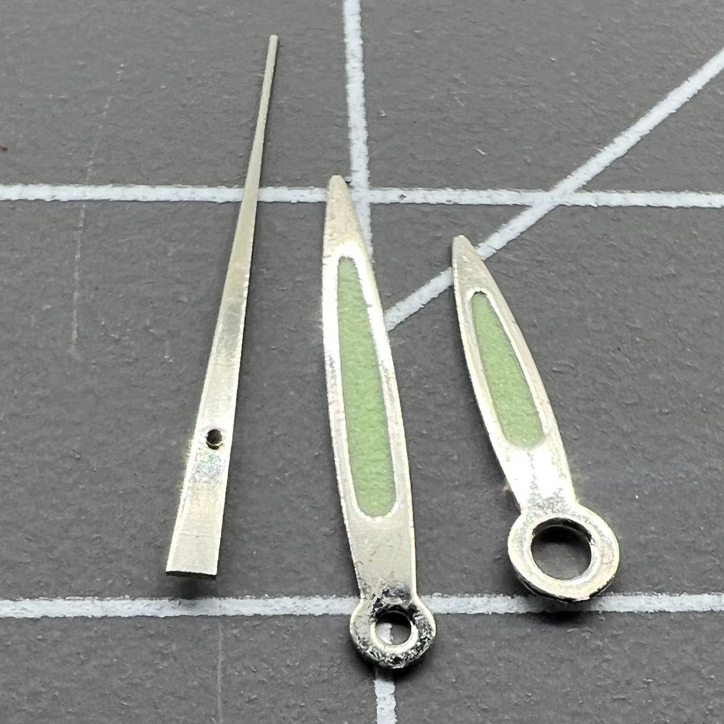 Arrow-shaped green luminous watch hands set from, compatible with Miyota 2035/2115/2105/2305 movements for precise timekeeping.