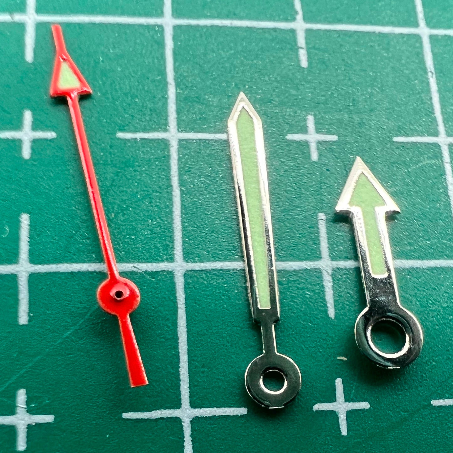 Green luminous arrow-shaped watch hands set by Miyota for models 2035, 2115, 2105, 2305, improving dial readability.