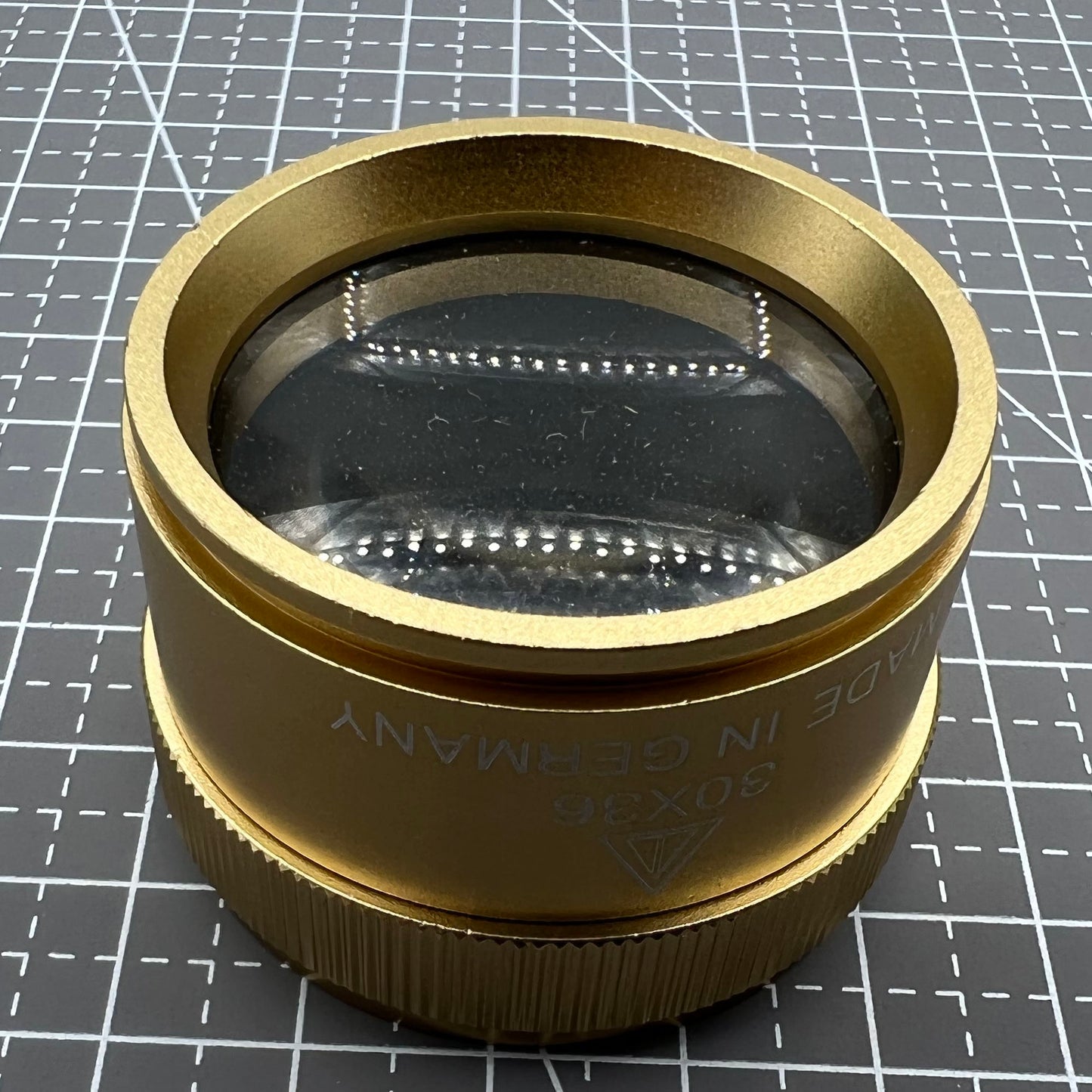 Bright golden 30X magnifier loupe by Germany Made for precise watch repair and detailed jewelry inspection.