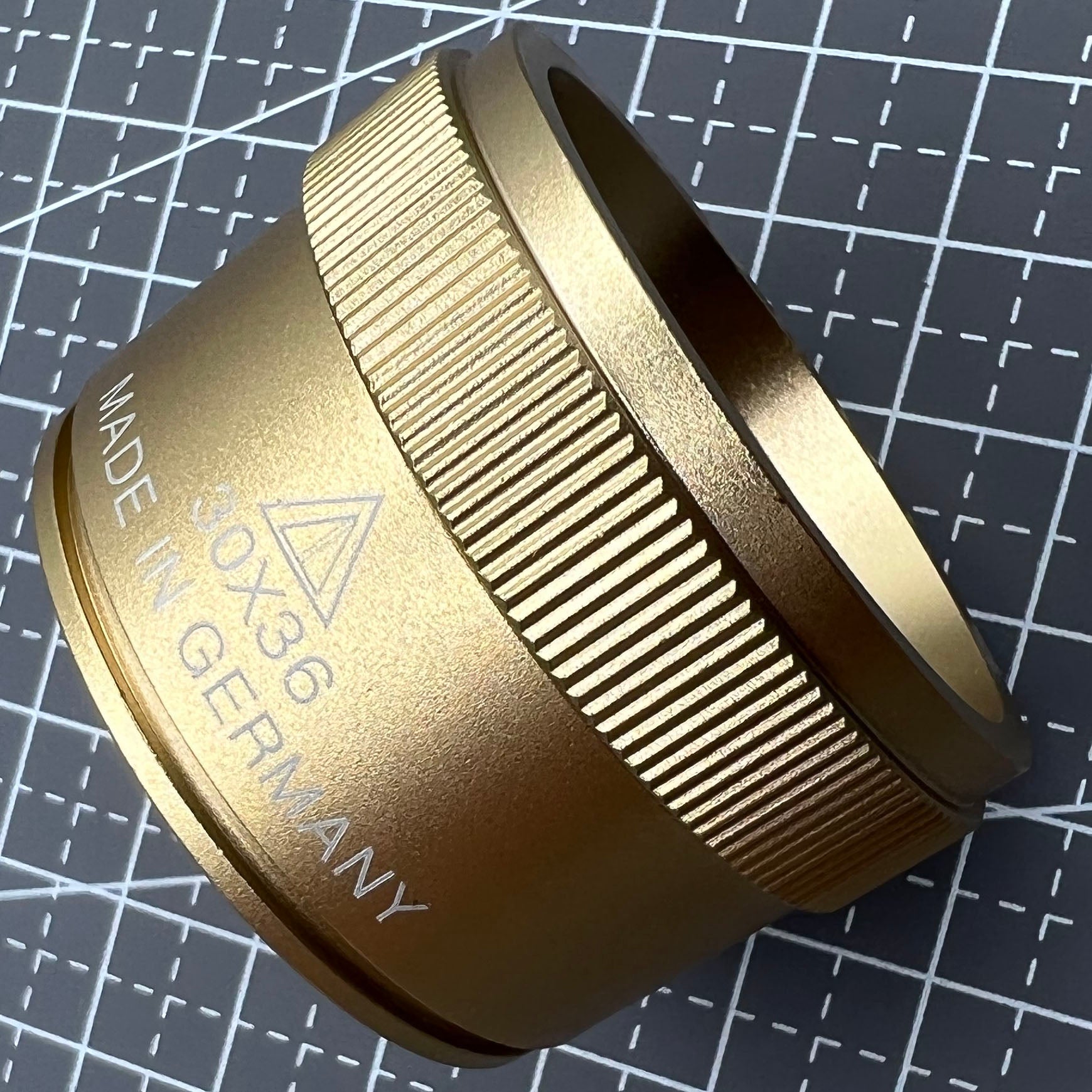 Bright golden 30X magnifier loupe by Germany Made for detailed watch repair and jewelry inspection.