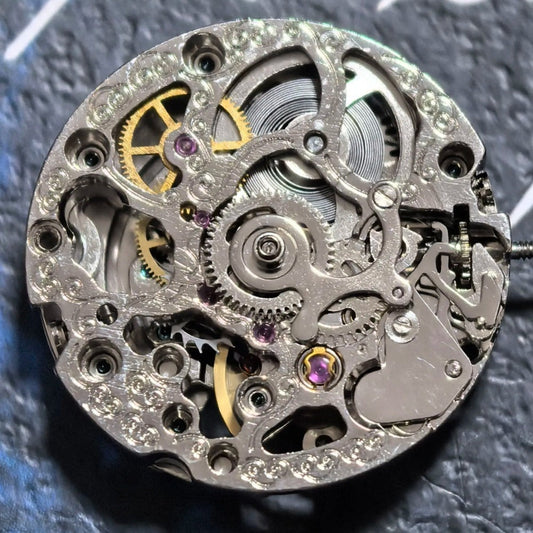 Silver hollow mechanical watch part with rose gold rotor, China made, for precise timepiece repairs.