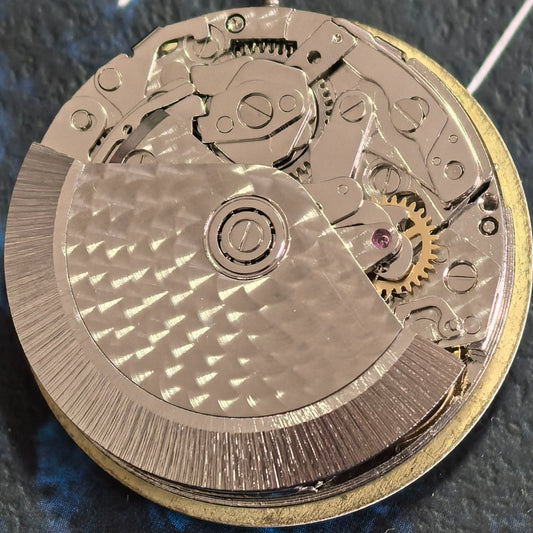 Chinese Dandong 7750 mechanical watch with single calendar and small seconds at 6, 9, and 12 o'clock positions.