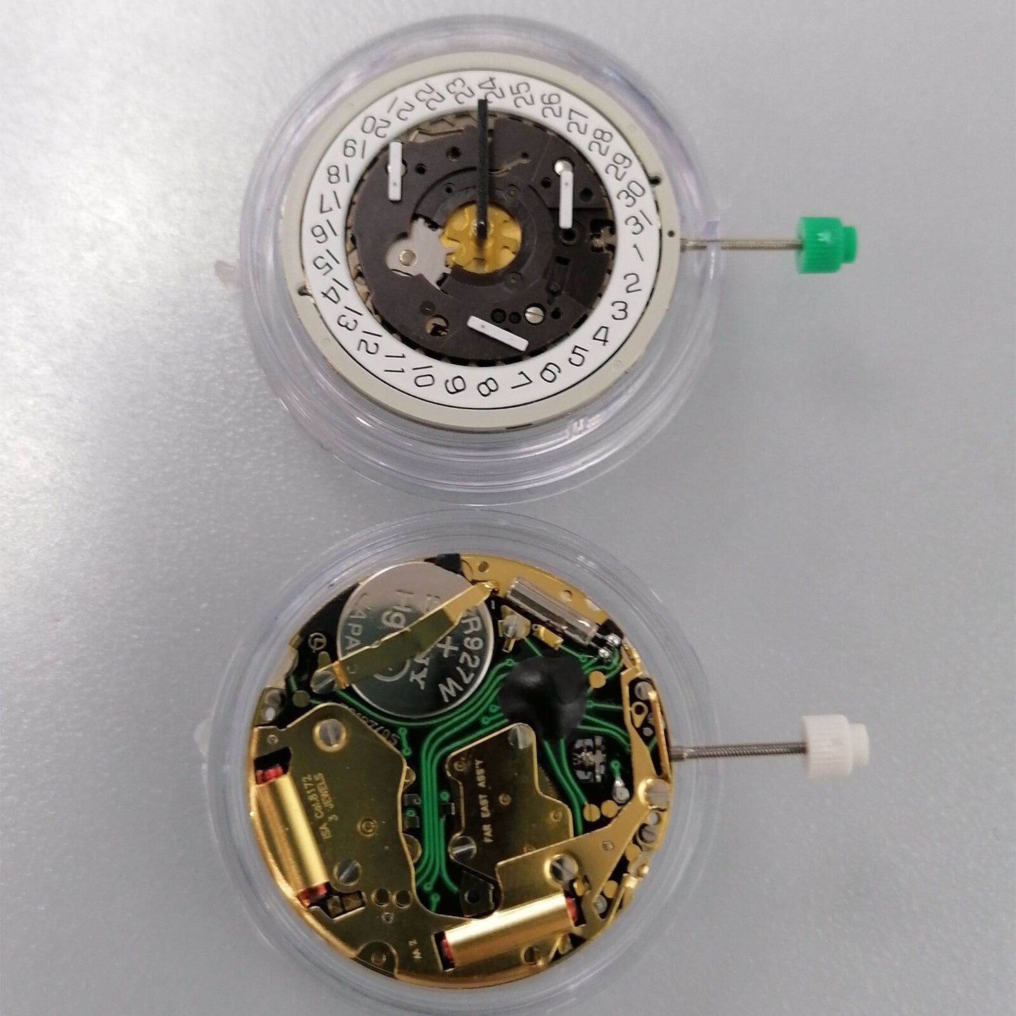 Watchmakers ISA 8172 golden quartz movement with date display at 4 o'clock and watch stem for precise timekeeping.
