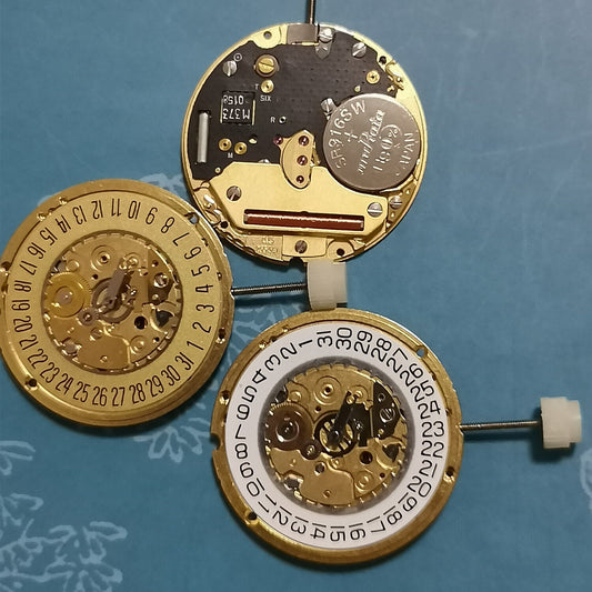 ETA 255.441 Swiss Quartz watch movement with white and golden disk, date window at 3/6, showcasing 2 hands.