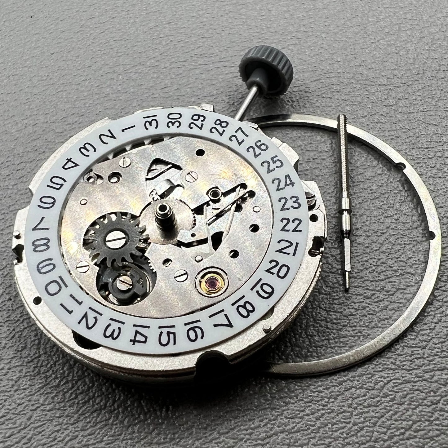 Close-up of Japan Miyota 8200 movement with single date display at 3 o'clock on watch accessory.