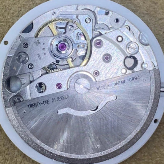 Close-up of New Japan Made Miyota 8285 mechanical watch movement with Arabic font date disk