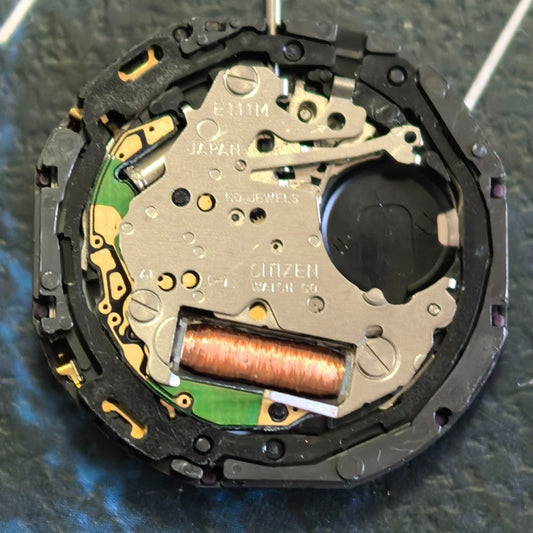 Citizen E111M Eco-Drive quartz watch movement with solar power and date display at 3 o'clock.