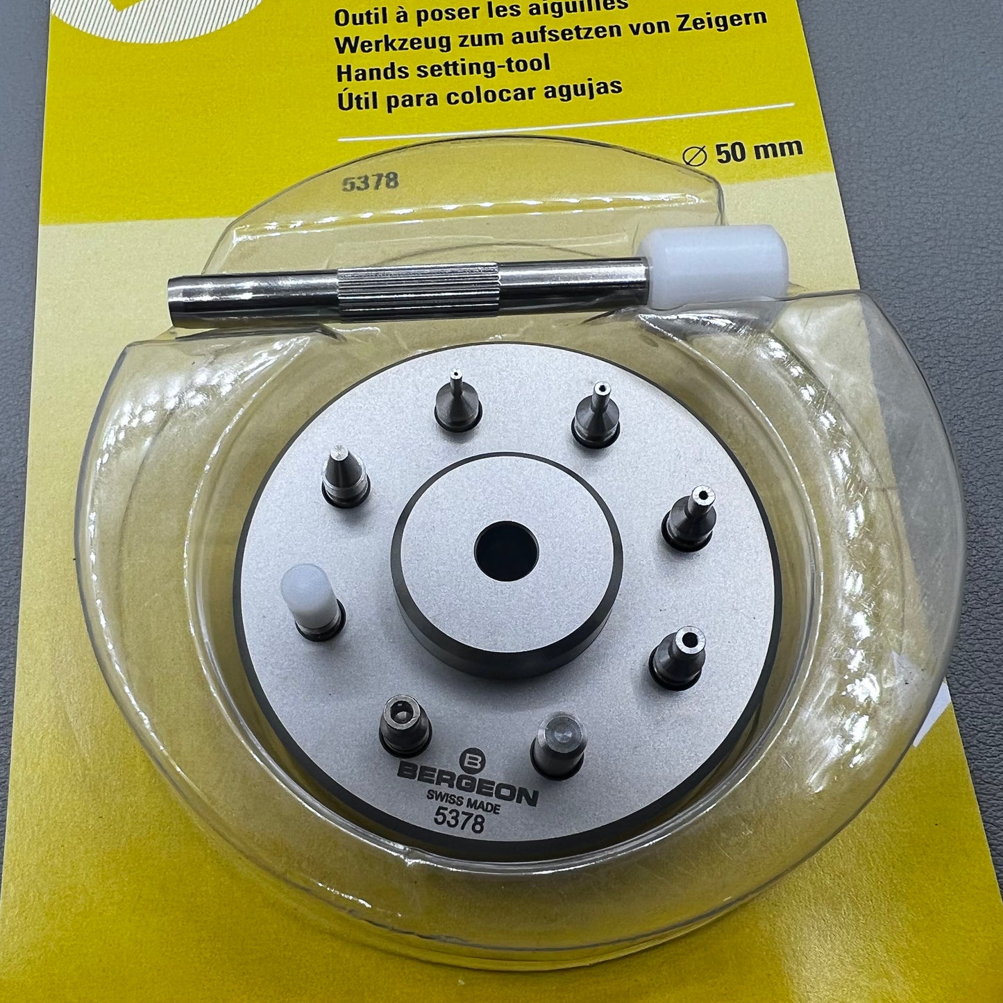 Swiss Bergeon 5378 watch hand fitting tool with 9 stakes on holder for precise hand installation.
