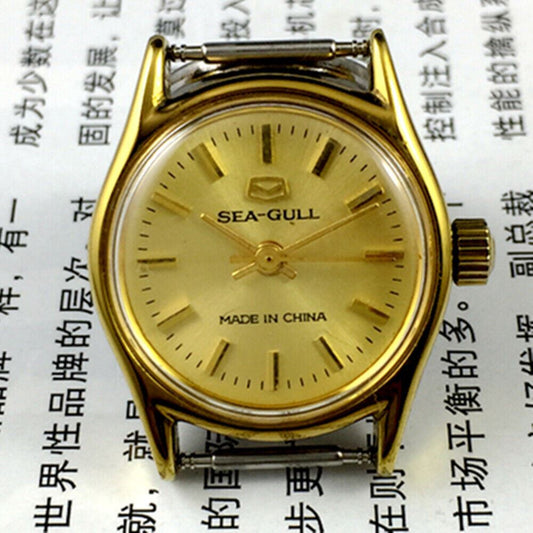 Round gold-tone case ladies watch with golden nail markers, manual mechanical movement by Tianjin Seagull.