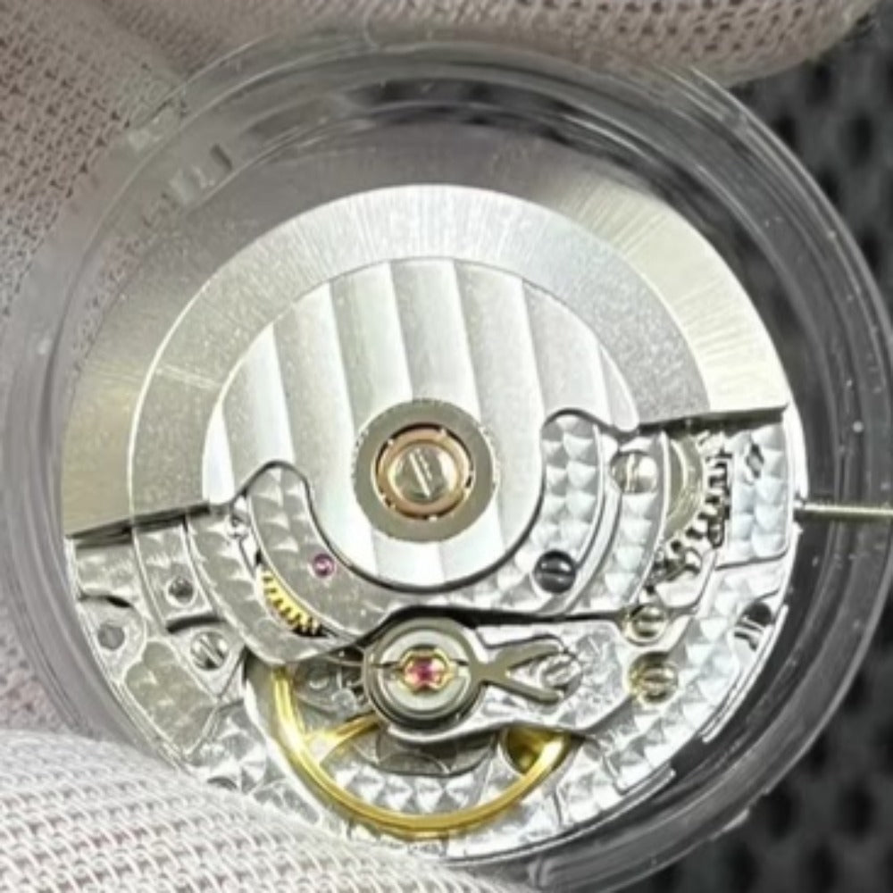 Asian 7750 automatic chronograph movement showing day-date at 3 o'clock, high precision ETA style mechanism