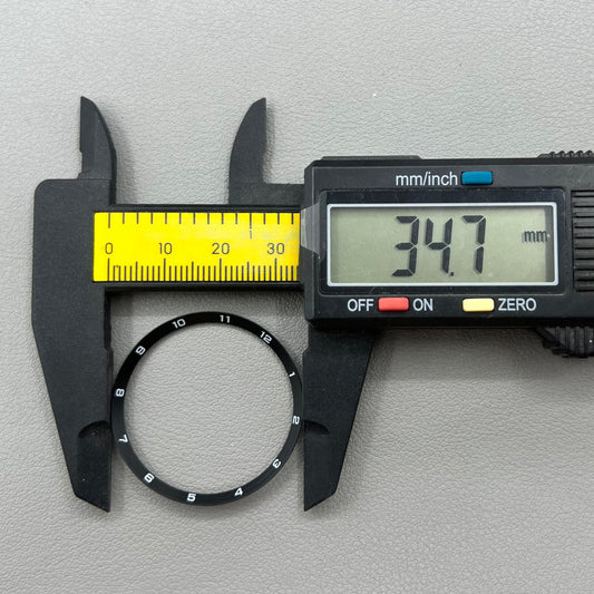 Black stainless steel chapter ring 34.9mm x 31.0mm x 1.9mm for watch accessory.