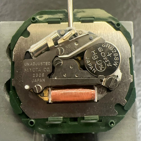 Japan-made Miyota 2305 quartz watch movement with black disk, day-date at 6, for precise timekeeping.