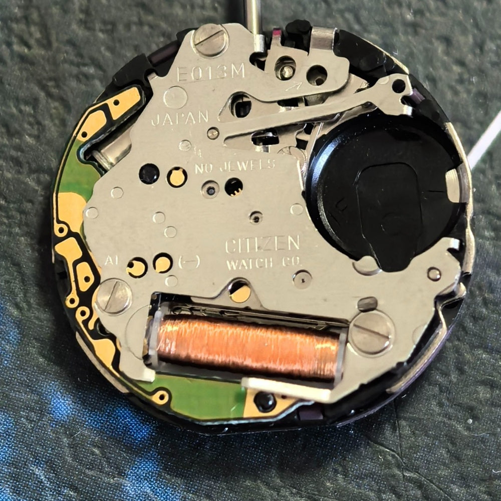 Citizen Eco-Drive E013M quartz watch movement with solar power and date display at 3 o'clock.