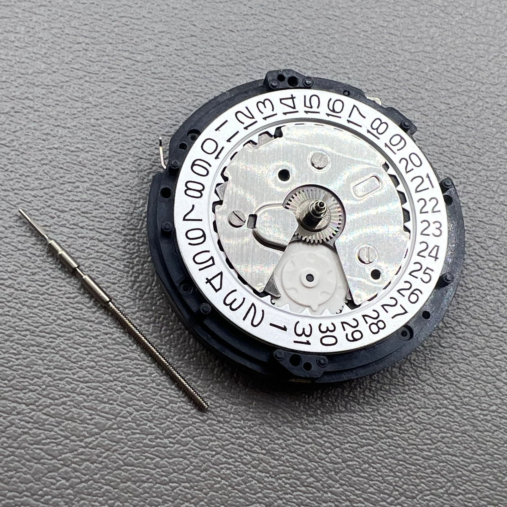Seiko 5M85A quartz watch movement close-up, precise mechanism for reliable timekeeping by Seiko.