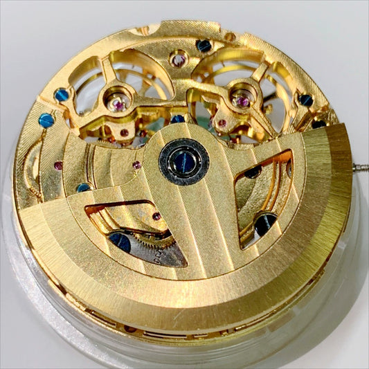 Shanghai branded golden double balance wheel watch accessory showcasing hollow design and three-hand mechanical movement.