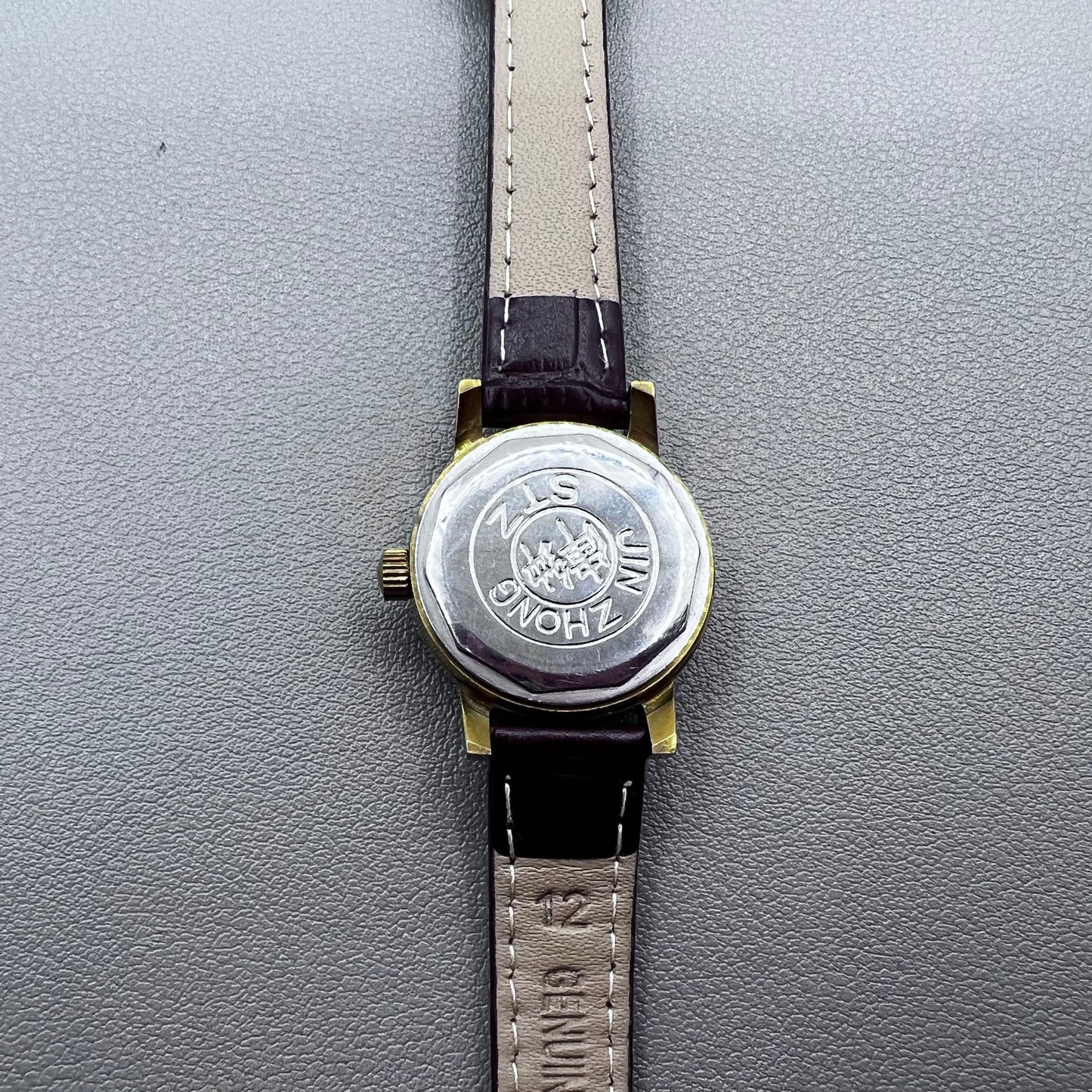 Dark Brown Strap Round Case 3 Hands Purple Background Manual Mechanical Watch