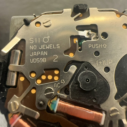 Epson VD59 quartz movement with small second subdial at 6, 9, and 12 positions for precision watch repair.