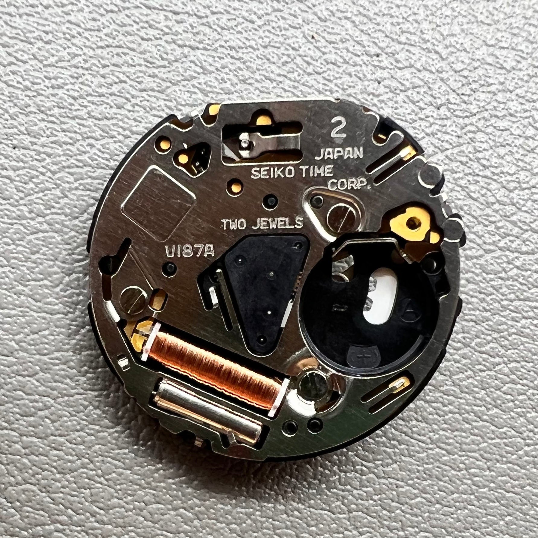 Seiko V187 quartz watch movement showcasing precision timekeeping components.