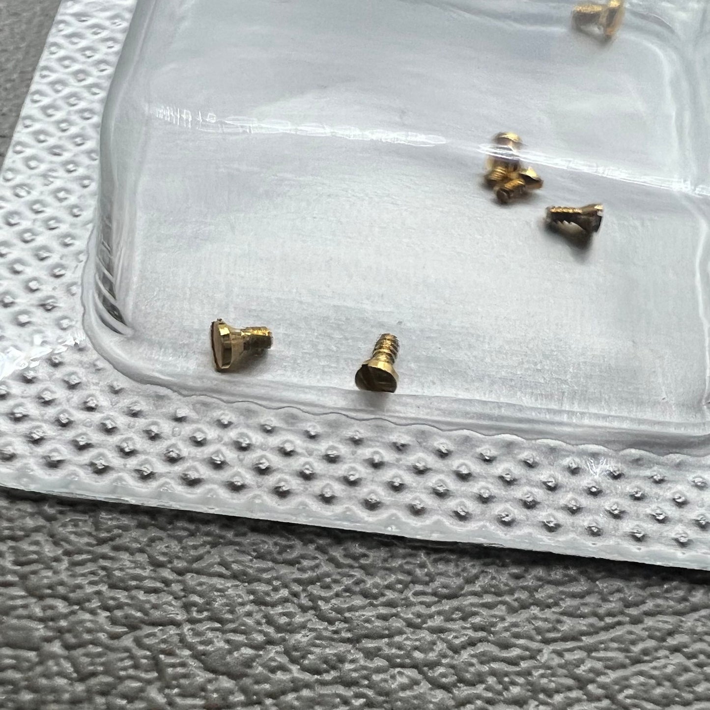 Set of 6 L4.209.4 watch case back screws, 1.2�0.7�1.7mm, for precise watch repair and maintenance.