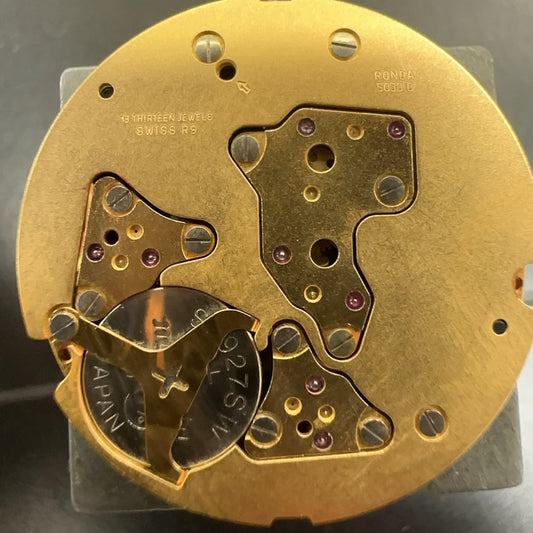 Swiss Made Ronda 5030D quartz movement with black date disk at 4 o'clock for watch repair.