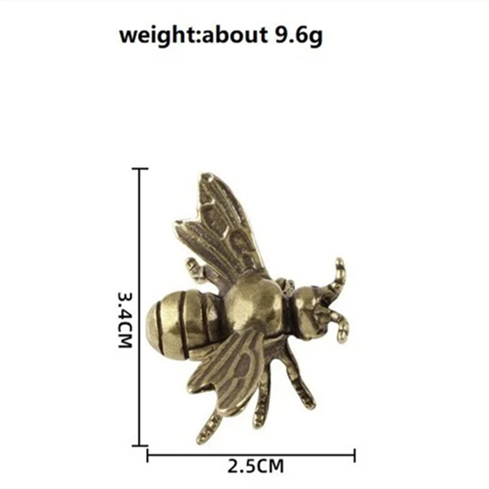 Solid copper bee trinket with vintage hand-carved bronze accents for watch accessory display.