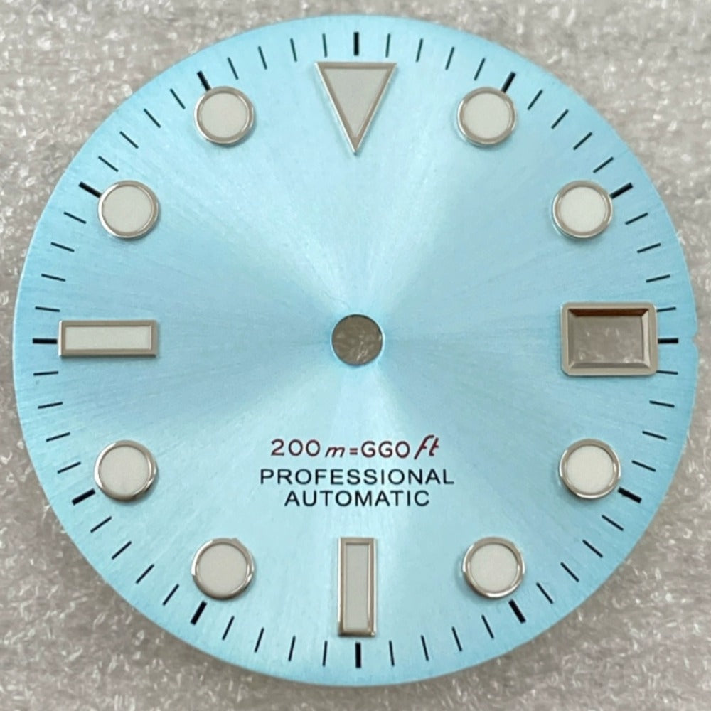 Green lume nail watch dial with silver trim on light blue background, compatible with NH35/36 movement.