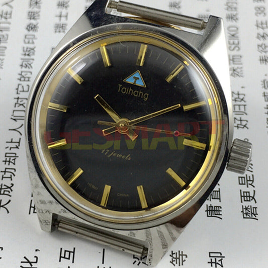 Chinese Taihang 32mm manual mechanical watch with 17 jewels, black dial, and golden nail markers.
