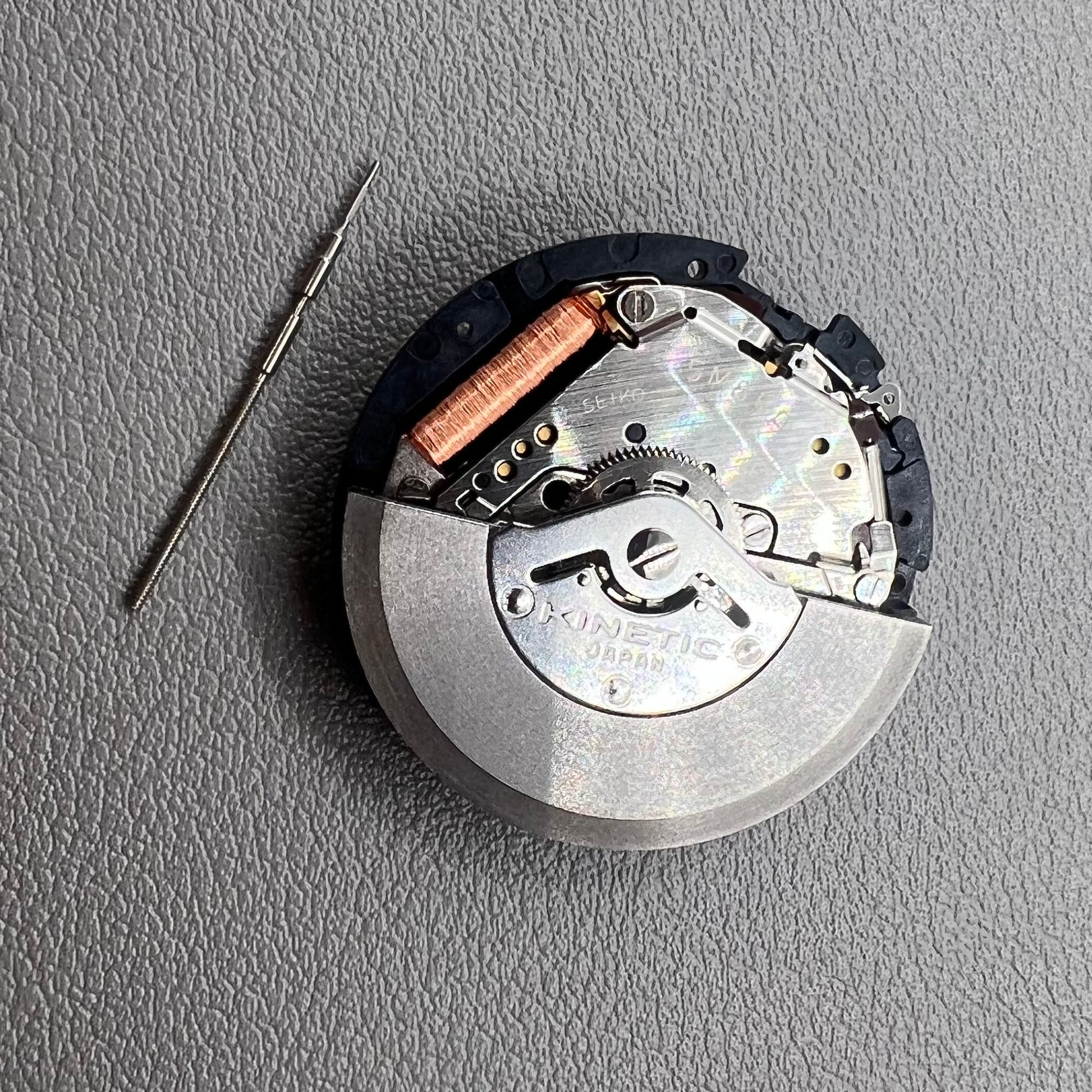 Seiko 5M85A quartz watch movement close-up, precise mechanism for reliable timekeeping by Seiko.