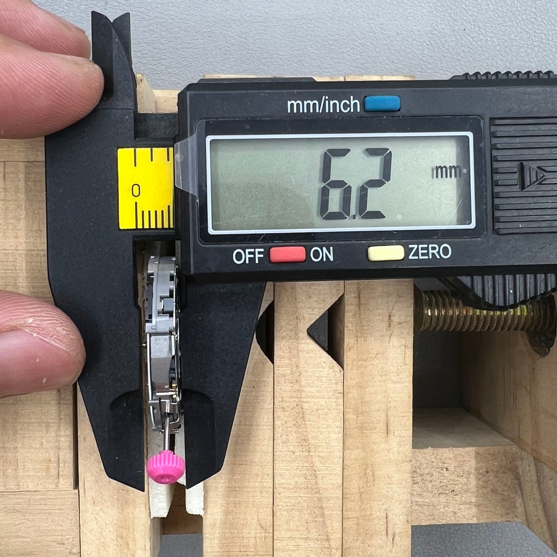 Japan Miyota JS25 watch movement close-up showing small second subdials at 3, 6, and 9 o'clock positions.