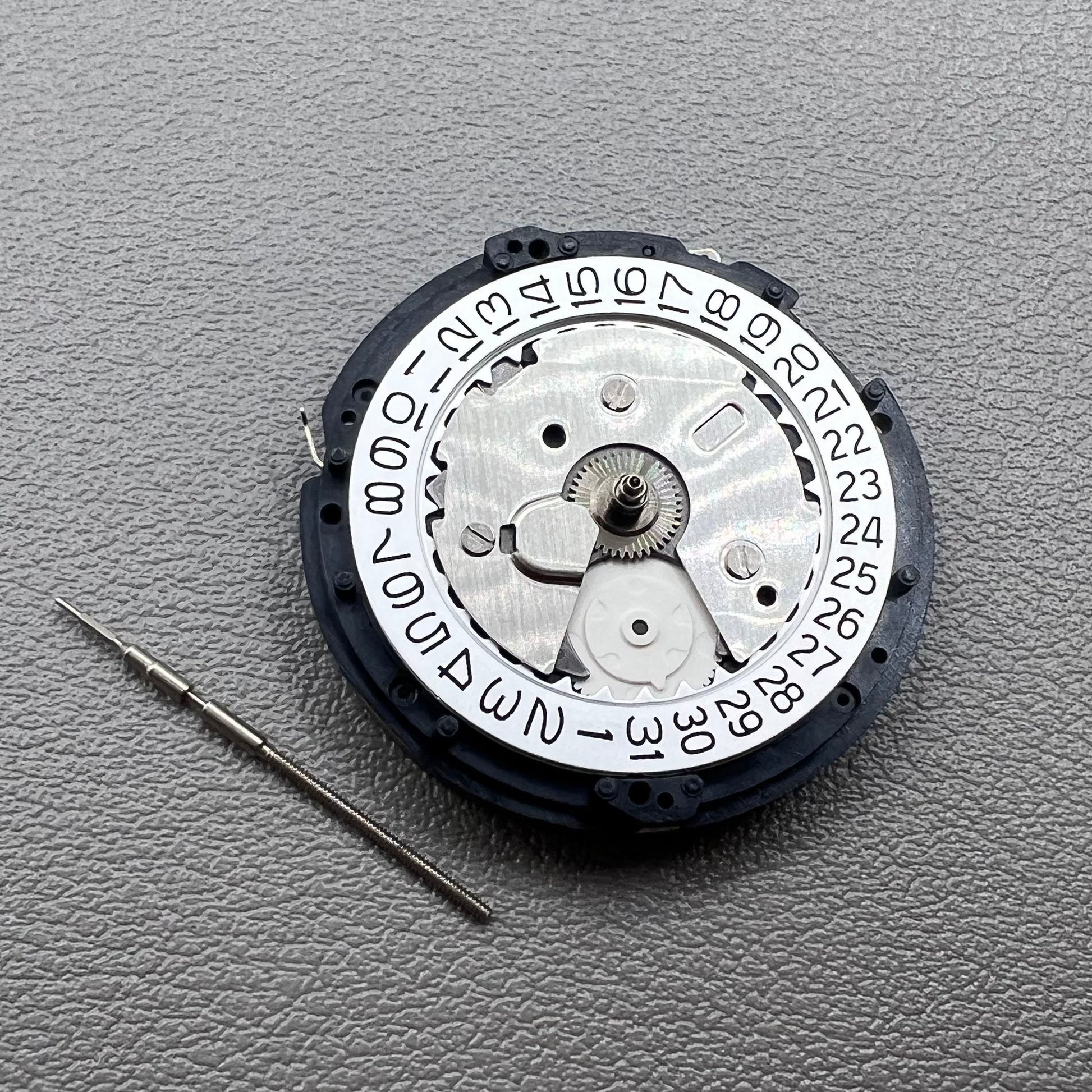 Seiko 5M85A quartz watch movement close-up showing precise, durable timekeeping mechanism by Seiko.