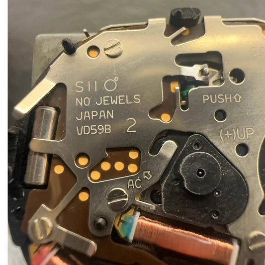 Original Japan Made VD59 quartz watch movement showing small second hands at 6, 9, and 12 o?clock positions.