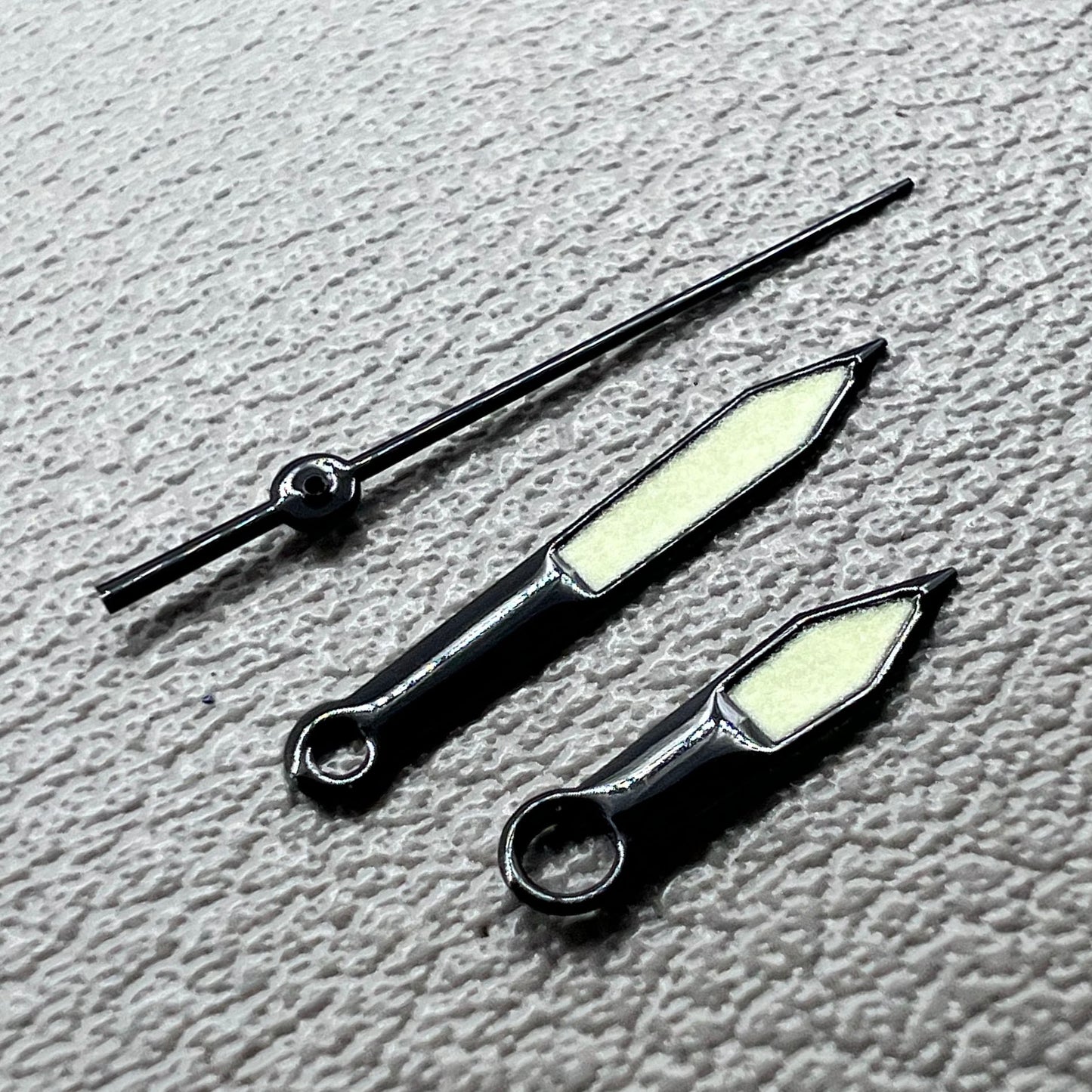 Black trim green lume watch hands set for Miyota 8215 with luminous tips, perfect for watch repairs and upgrades.