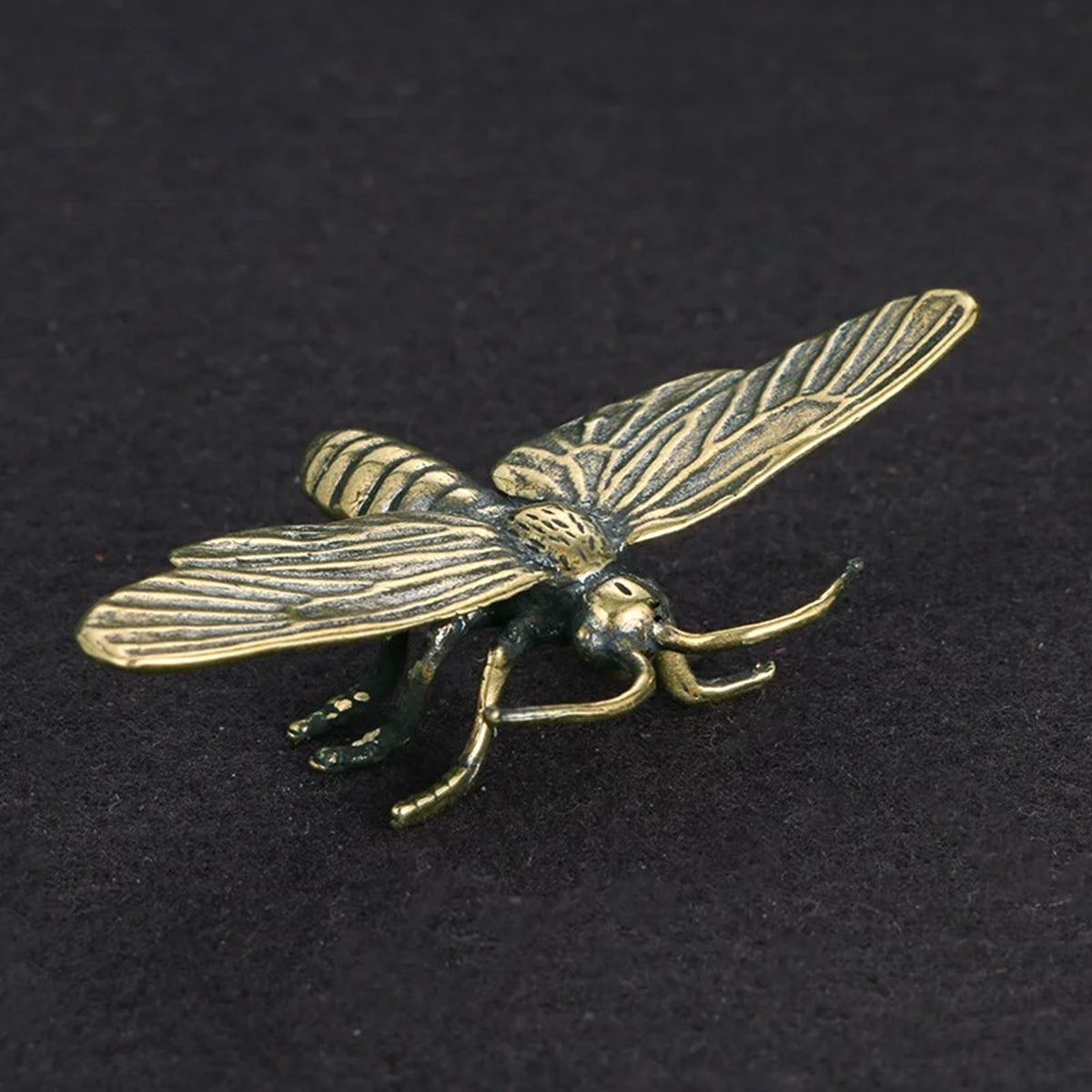 Solid copper dragonfly trinket with vintage bronze finish and hand-carved details, ideal for watch accessory display.