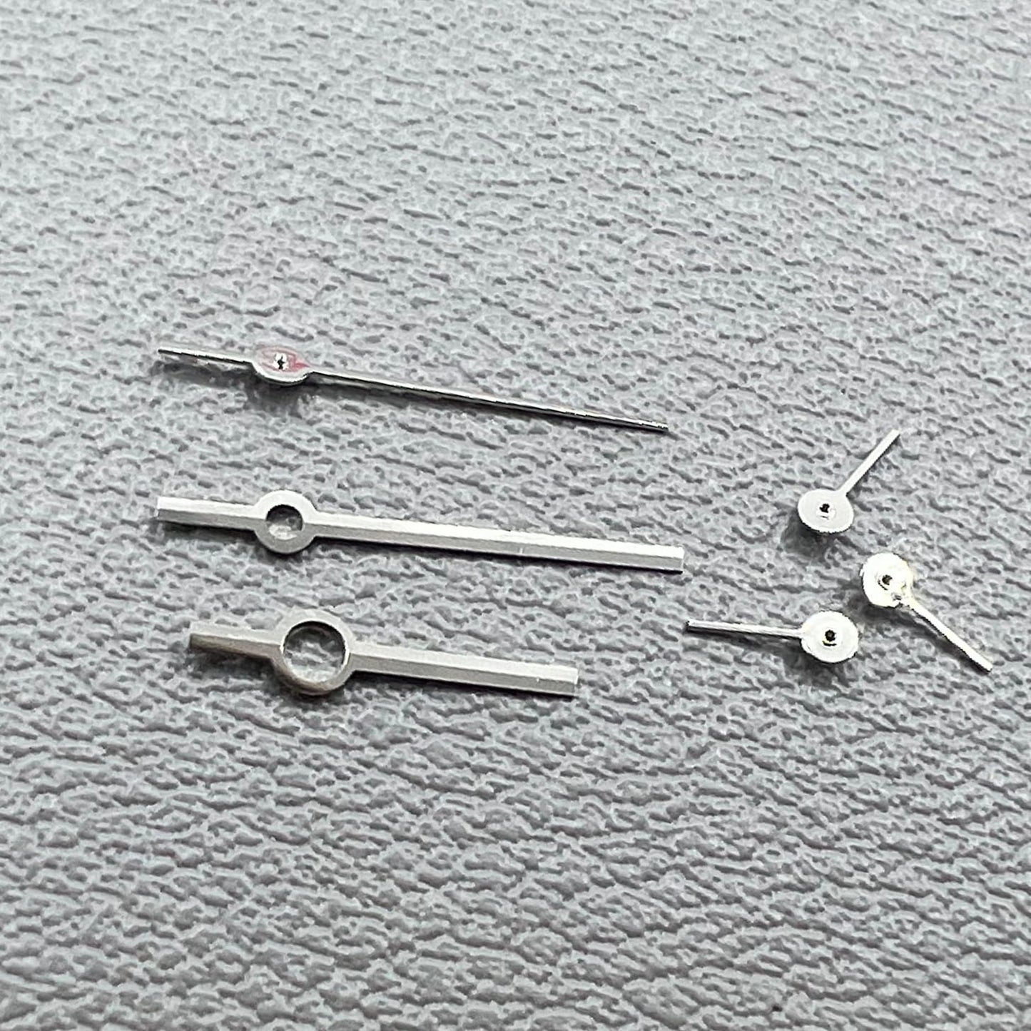 Silver watch hands set for Ronda 5030.D quartz movement, precision timepiece parts.