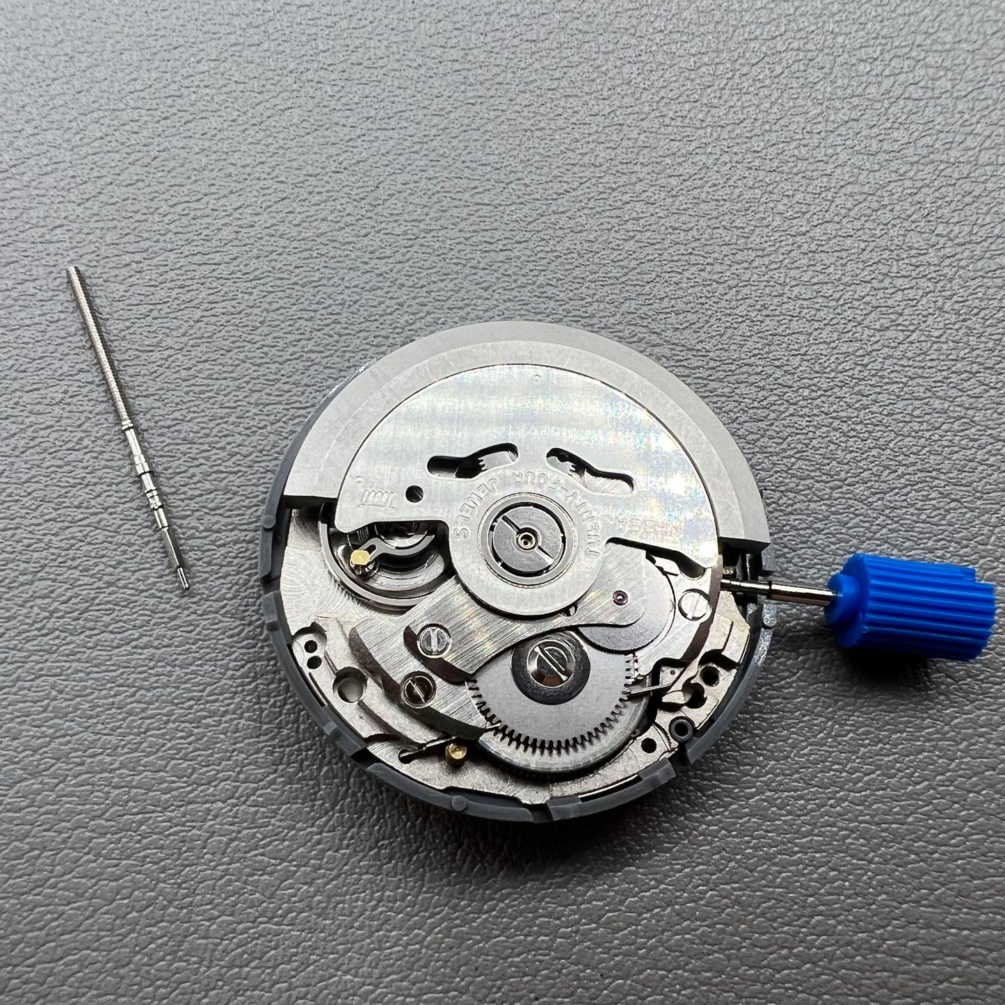 Seiko NH35 automatic watch movement with dark yellow disk, precise mechanical timekeeping by Japan.