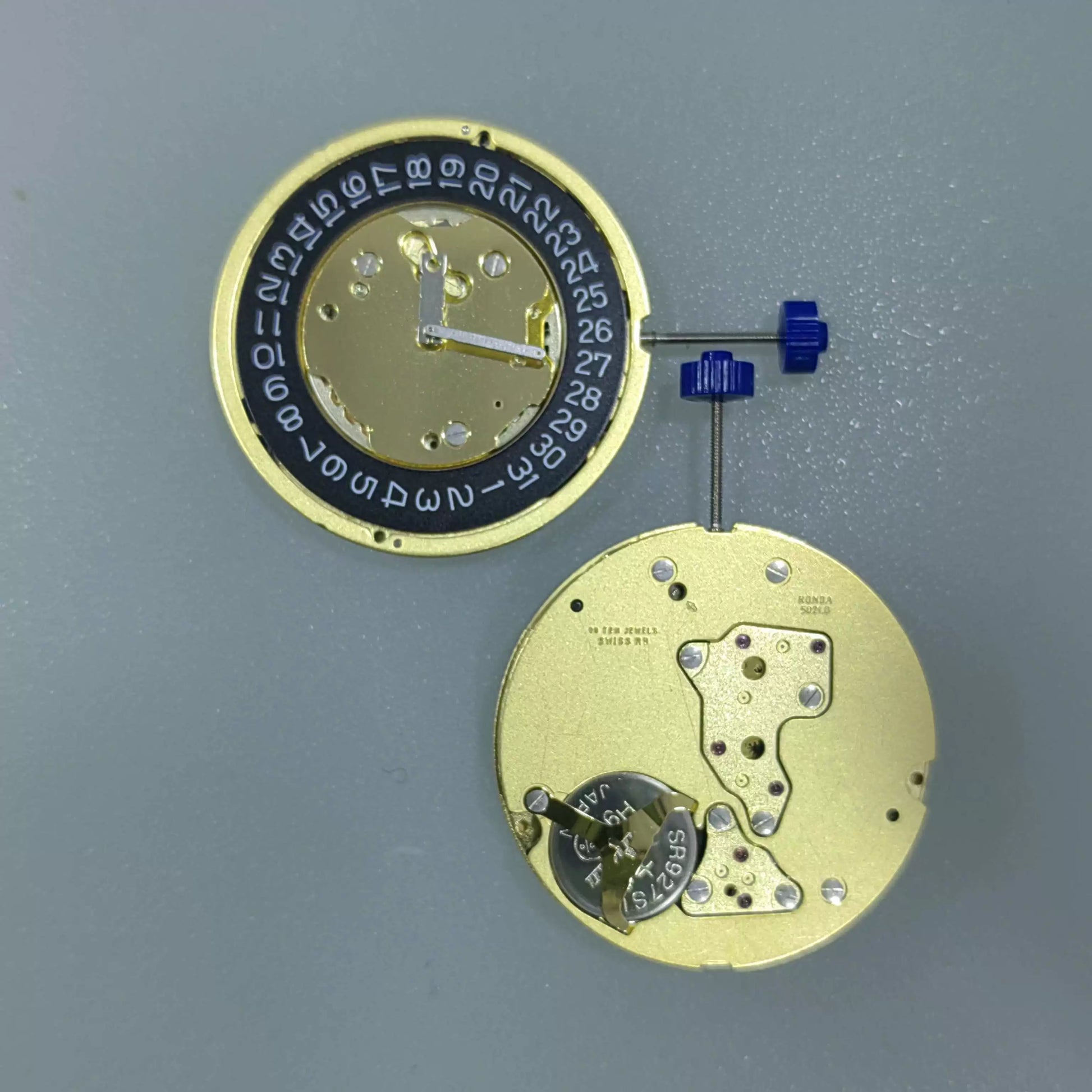 Swiss Made Ronda 5021.D quartz watch movement with date window at 3 o'clock and black disk.