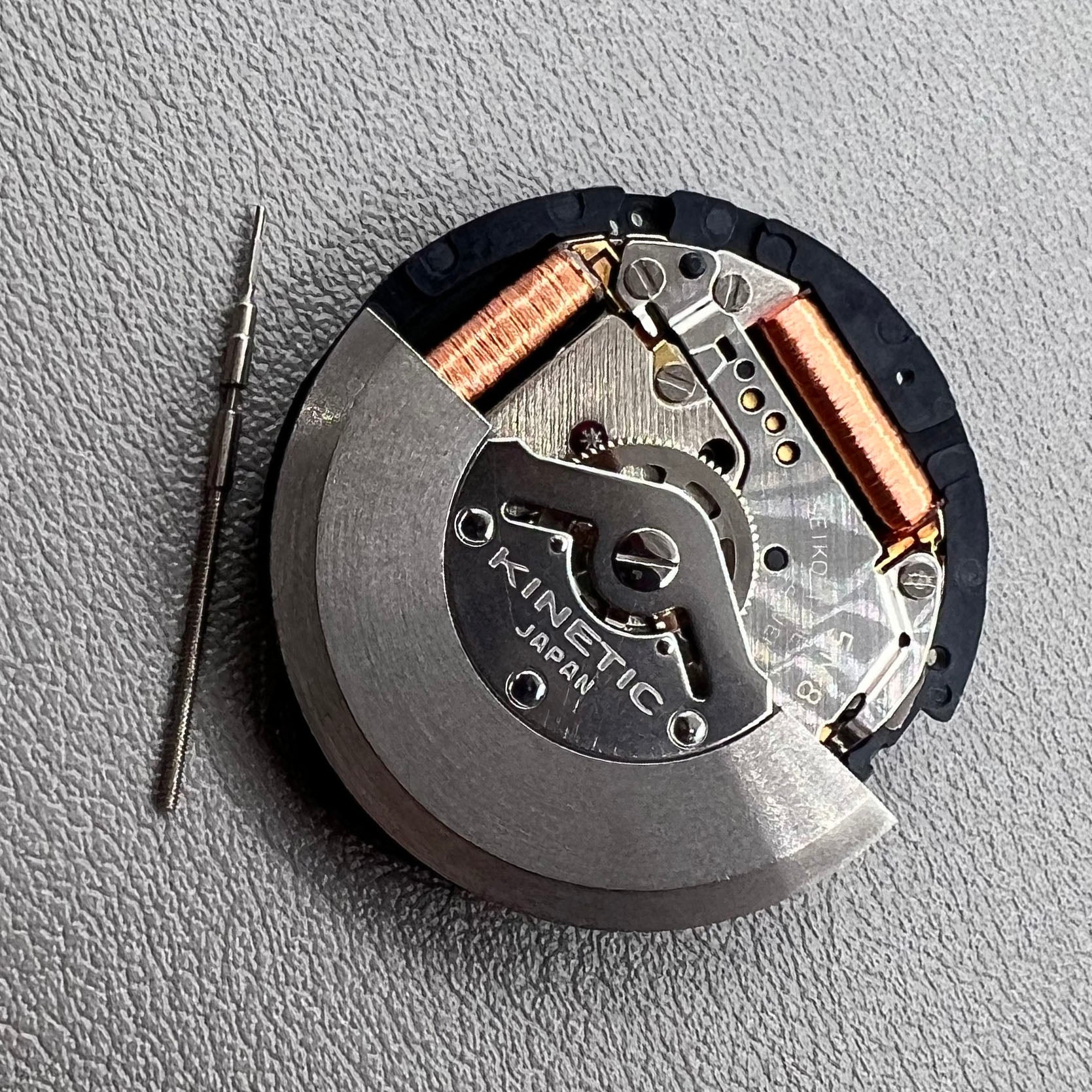 Seiko 5M85A quartz watch movement close-up, precise and durable mechanism for accurate timekeeping.