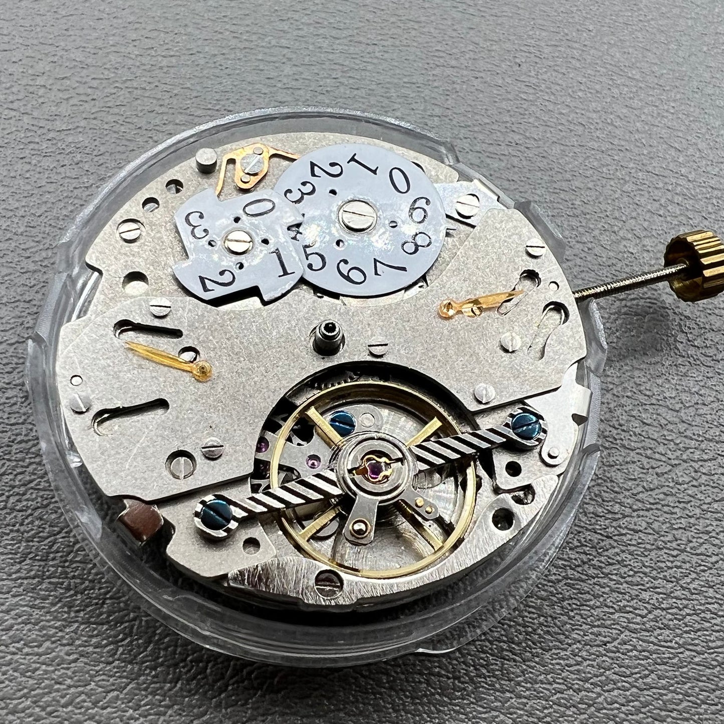 Wenzhou Mechanical watch movement with bare balance wheel and big date display at 12 o'clock.