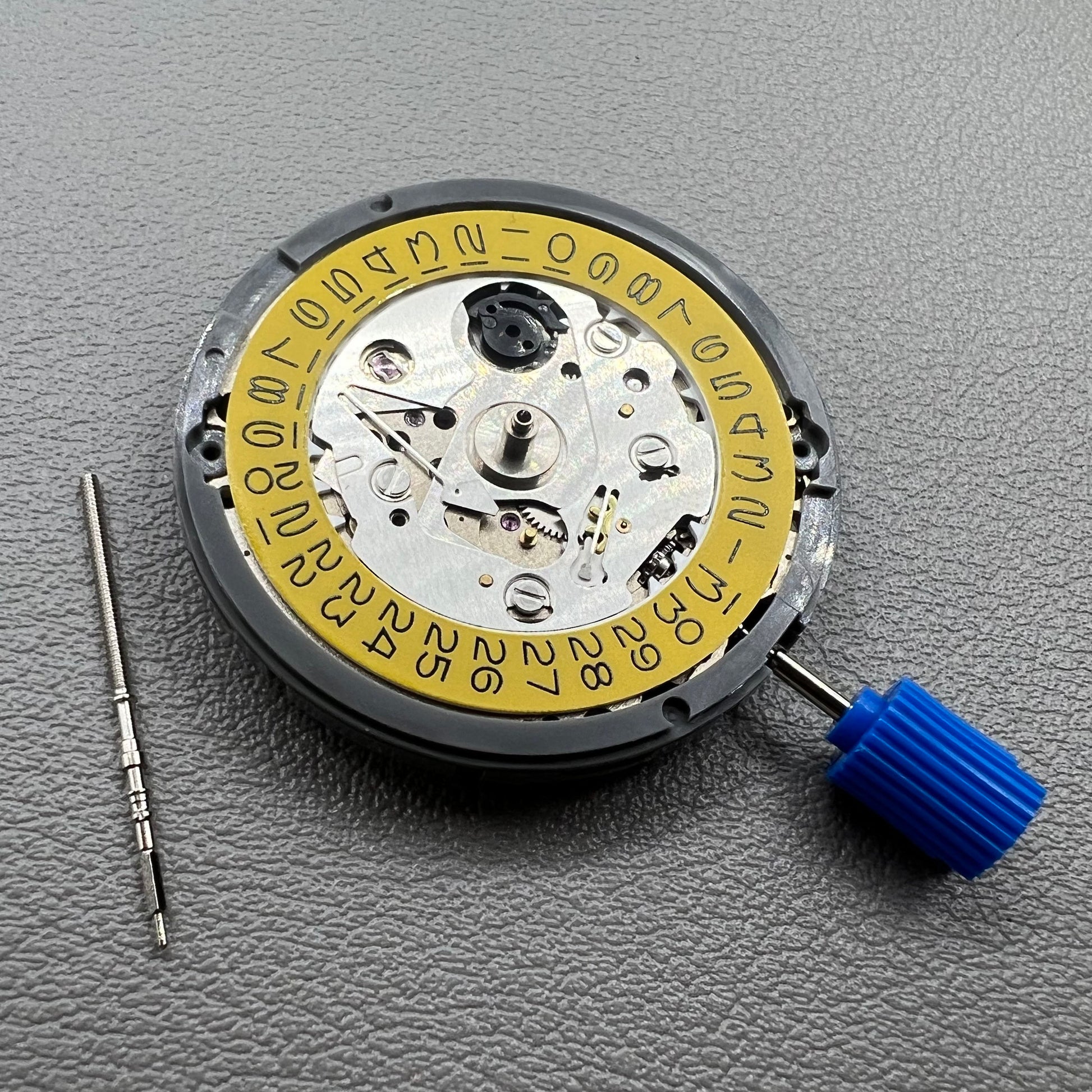 Seiko NH35 automatic watch movement with dark yellow disk, precise mechanical timekeeping by Japan.