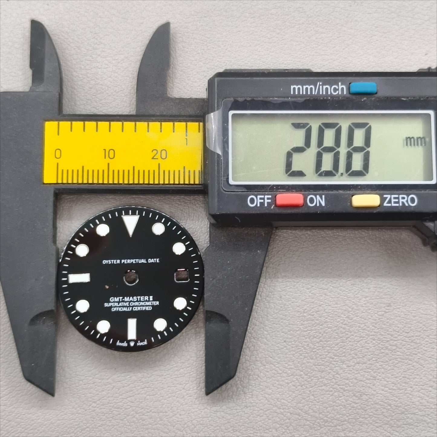 watch dial with R logo