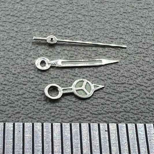 Silver trim green luminous watch hands set for Miyota 1M12 movement, enhancing visibility and style.