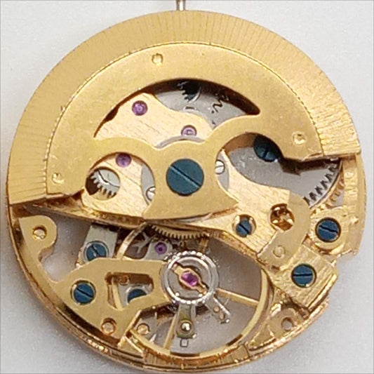 Dandong 7120 golden watch part with mechanical movement and skeleton 3-hand design for repairs.