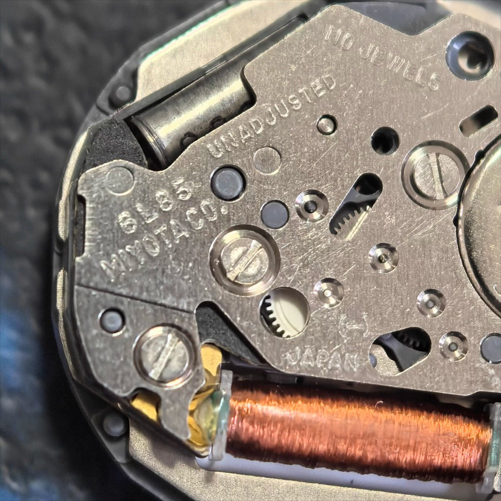 Miyota 6L85 quartz watch movement with date at 6, moonphase, and three hands by Japan Made.
