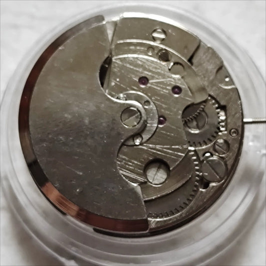 China Made 7120 mechanical watch movement showing moon phase at 6 and bare wheel at 9.