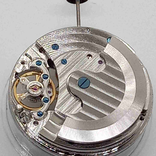 Silver mechanical flywheel watch part, precision movement component for watch repair and assembly.