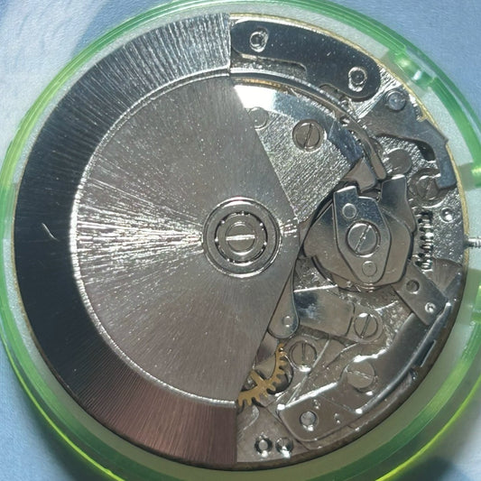 Dandong 7750 mechanical watch movement showing 7 hands with small seconds at 6, 9, and 12 o'clock positions.