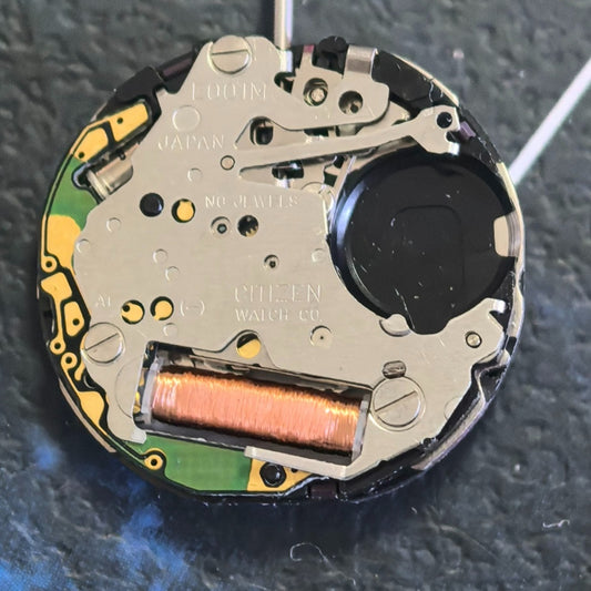 Citizen Eco-Drive E001 quartz watch movement showing solar-powered day and date display at 3 o?clock.