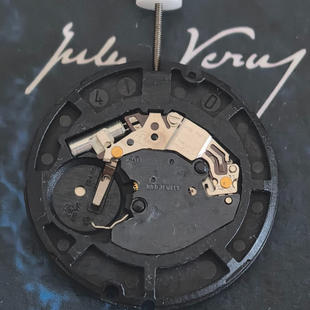 Swiss Made ETA805.144 quartz watch repair part with three white hands and disk for precise timekeeping.