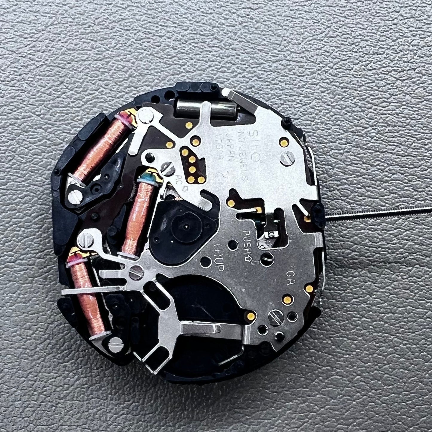 Original Japan VD59 watch movement close-up showing multifunctional quartz small second at 6/9/12 o'clock positions.